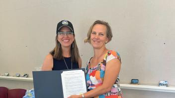 Tara Thronson of Yolo County Supervisor Lucas Frerichs Office presents an award to Dr. Brinkley